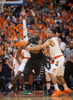 Baye Moussa Keita (left) and Michael Gbinije (right) defend Jordan Reed of the Bearcats.