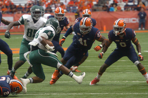 Syracuse linebacker Lewellyn Coker braces for a tackle. The Orange held Wagner to just 87 total yards.