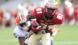 Dyshawn Davis tries to bring down Kenny Shaw. No. 2 Florida State finished with 523 total yards of offense in a 59-3 win over Syracuse. 