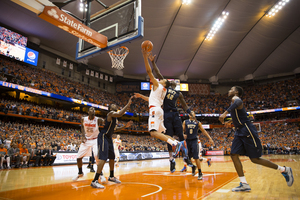 Tyler Ennis blows by Talib Zanna for a contested layup. Ennis finished with 16 points, sparking No. 2 Syracuse to a staple win over Pittsburgh. 