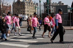 Men in high heels walk through Clinton Square in downtown Syracuse in support of the Vera House's campaign to end domestic abuse. 