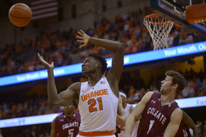 Tyler Roberson extends his arms to reach for the ball in Syracuse's 50th straight win over Colgate on Tuesday night in the Carrier Dome.