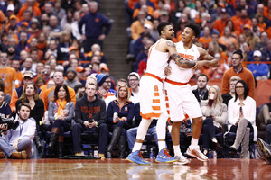 Malachi Richardson is held back by Michael Gbinije. Richardson got heated after getting tied up with Notre Dame's Matt Ryan.