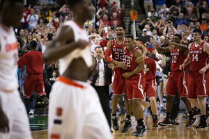 North Carolina State players celebrate after beating Syracuse in the quarterfinals of the 2014 Atlantic Coast Conference tournament.