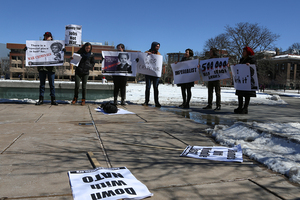 Syracuse University students brandished signs protesting the Madeleine Albright lecture at Hendricks Chapel on Tuesday. They chanted, 