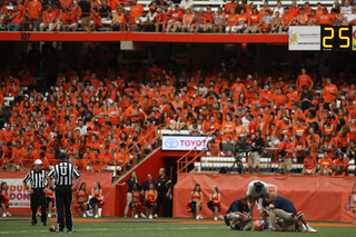 Syracuse quarterback Ryan Nassib is attended to after getting the wind knocked out of him in the first half.