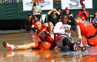 Brandon Triche of the Syracuse Orange fights for the ball against Jamaal Franklin of the San Diego State Aztecs during the Battle on the Midway game on Sunday.