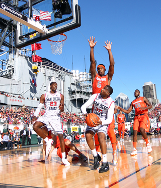 JJ O'Brien and DeShawn Stephens of the San Diego State Aztecs shoot the ball against C.J. Fair of the Syracuse Orange during the Battle on the Midway game on Sunday.