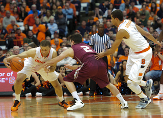 Brandon Triche dribbles against pressure from Colgate guard Mitch Rolls.