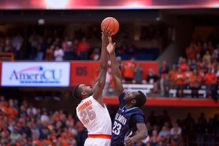 Syracuse forward Rakeem Christmas (25) rises above Villanova forward Daniel Ochefu (23) to control the tip.