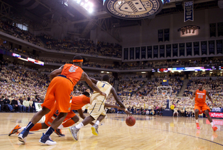 Pitt guard Tray Woodall dribbles away from Jerami Grant and C.J. Fair (5) late in the second half as the Panthers secured their win at the Petersen Events Center on Saturday. Pitt defeated the Orange 65-55 in the Big East matchup. 