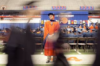 Previous Syracuse University professors take their seats as they march into the Carrier Dome.