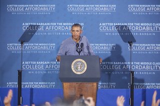 Spectators inside Henninger High School cheer as President Barack Obama leaves the stage. 