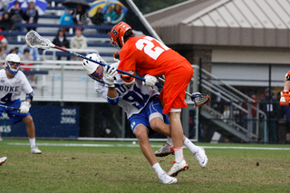 SU defender Sean Young decks Duke defender Luke Duprey in the midfield. 