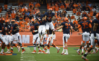 Syracuse defensive backs Julian Whigham (1) and Darius Kelly (8) celebrate.