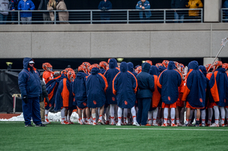 Syracuse huddles up on the sideline. 